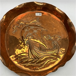 Newlyn School style large circular copper dish, the raised rim with crimped edge and repousse study of a Viking long ship in a rough sea, un,arked, D41cm