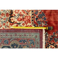 West-Central Persian Mahal hand-knotted carpet, terracotta field with a large central indigo and ivory medallion with floral palmettes and scrolling vines, framed by ivory spandrels with dense foliage within a broad navy border of lotus and palmette motifs linked by scrolling tendrils and multiple guard stripes 