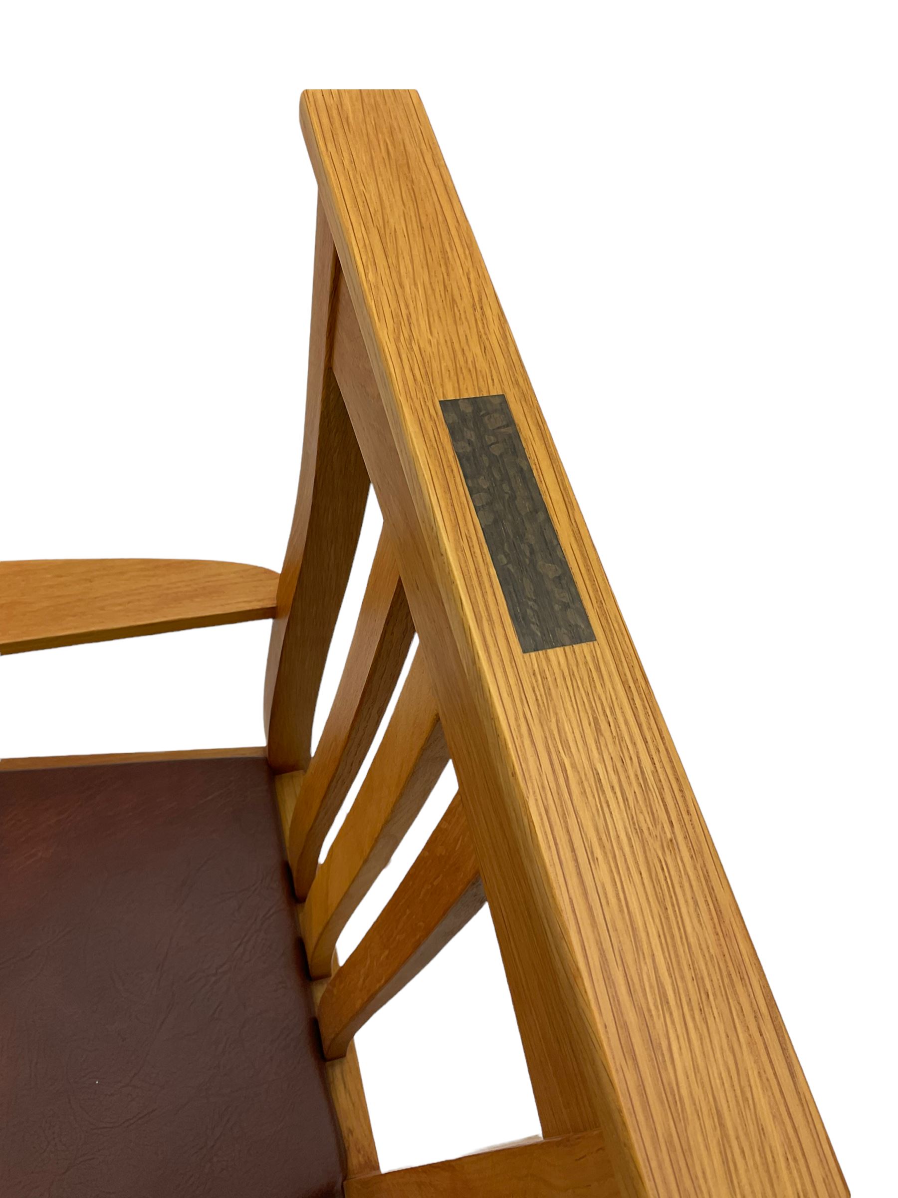 Pair of solid oak Arts and Crafts style carver chairs, inlay to top rail, drop in seat