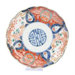 Group of 19th century Japanese Imari porcelain, Meiji period, comprising pair of lobed dishes, decorated stylised reserves and painels in blue and gilt upon a red ground, H6.5cm D21.5cm, a pair of plates of circular lobed form, decorated with a central panel depicting a vase beneath pine branches, and surrounded by panels of flowers and stylised quatrefoil shapes, D21cm, and another similar example painted with a character in underglaze blue to the centre, with character mark beneath, D22cm, each with character marks beneath               