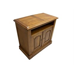 Medium oak television media cabinet, open compartment above two cupboard doors