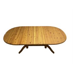 Pine extending dining table with additional leaf, on turned twin pedestals with splayed supports