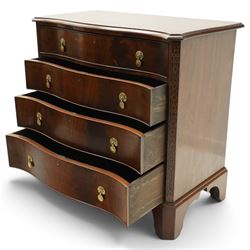 Quality Georgian design mahogany serpentine secretaire chest, the shaped top with moulded edge, fitted with cock-beaded secretaire drawer with button-release fall-front enclosing fitted interior, over three graduating drawers with brass drop handles on pierced circular plates, the canted uprights carved with blind-fret strapwork, lower moulded edge on shaped bracket feet