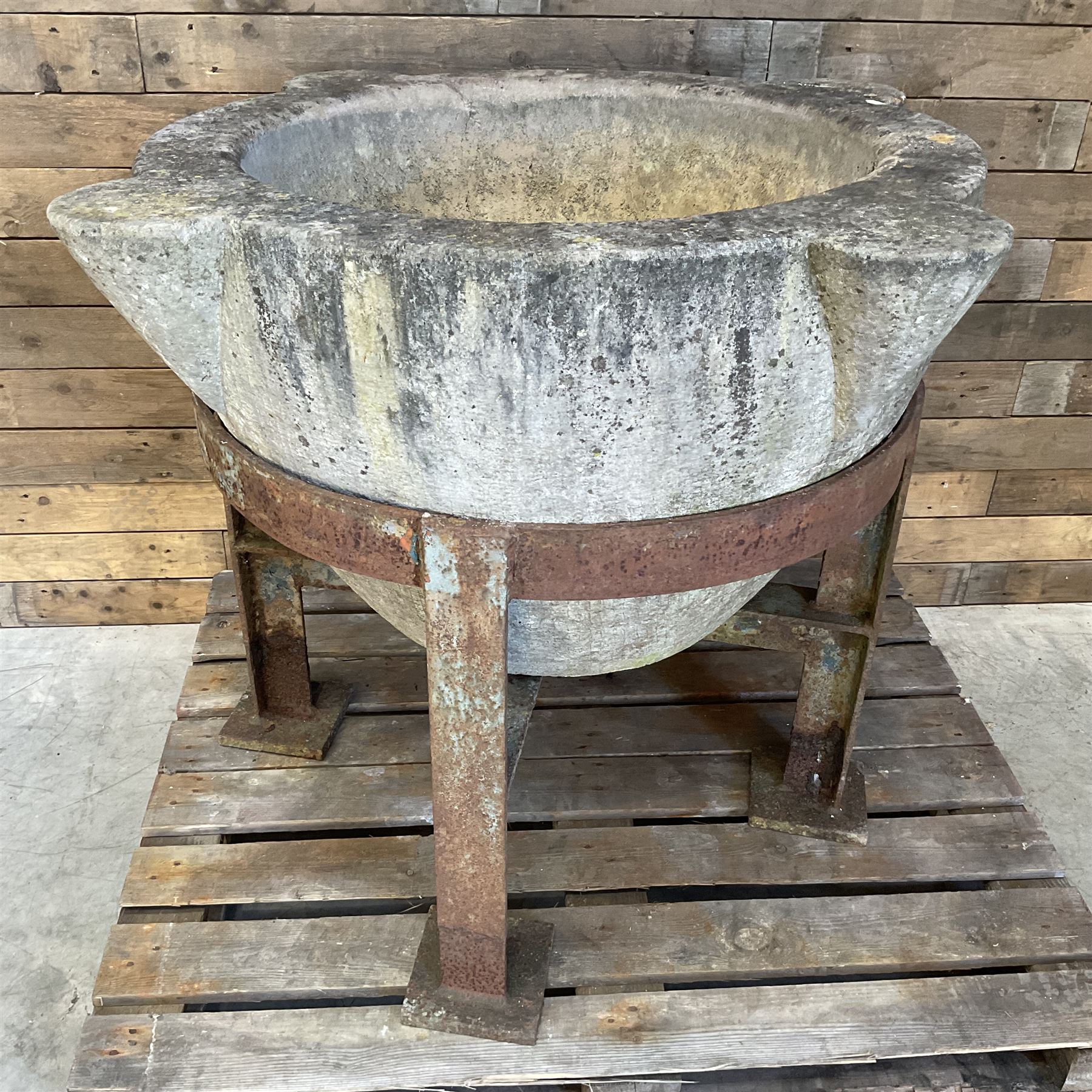 Large 19th century circular stone mortar planter on wrought iron stand