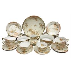 Early 20th century Limoges part tea service, decorated with floral sprays and gilt on merging peach and white ground, comprising six teacups, twelve side plates, six smaller plates, milk jug, open sucrier, slop bowl and two cake plates, many marked R Delinieres Limoges D&C France to base