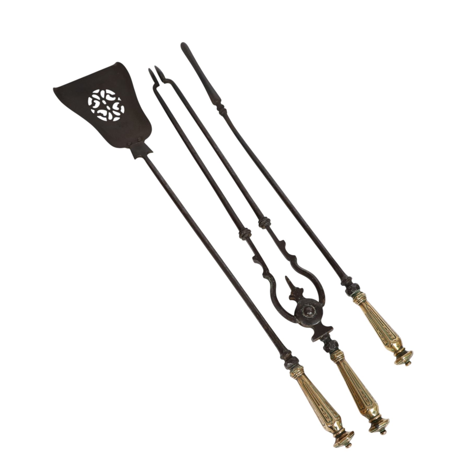 Set of three 19th century brass and steel fire irons, each with tapering and hexagonal capped handles, comprising poker, tongs and shovel with pierced detail, poker L84cm