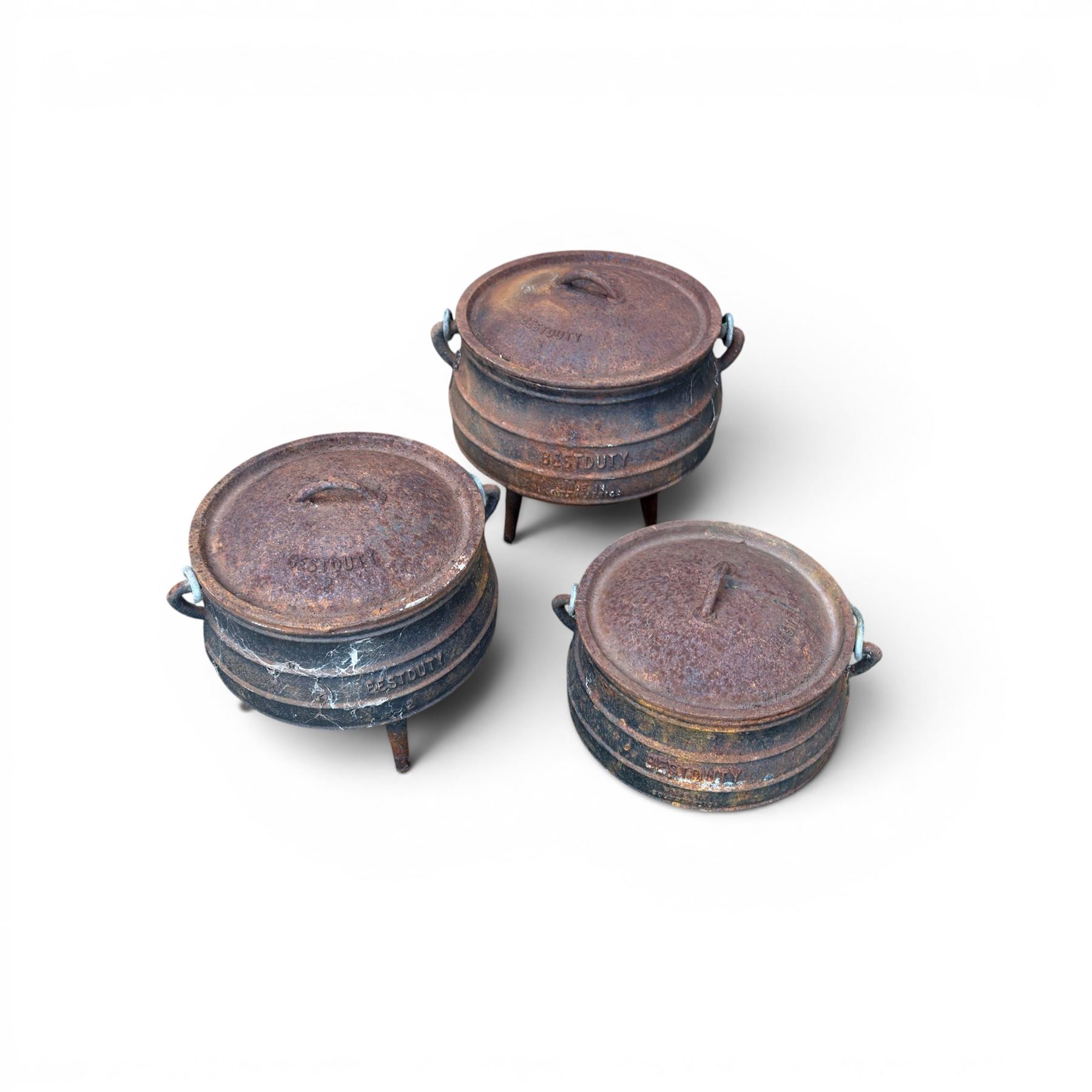 Three South African cast iron graduating cooking pots with lids and handles. Size shown for the largest