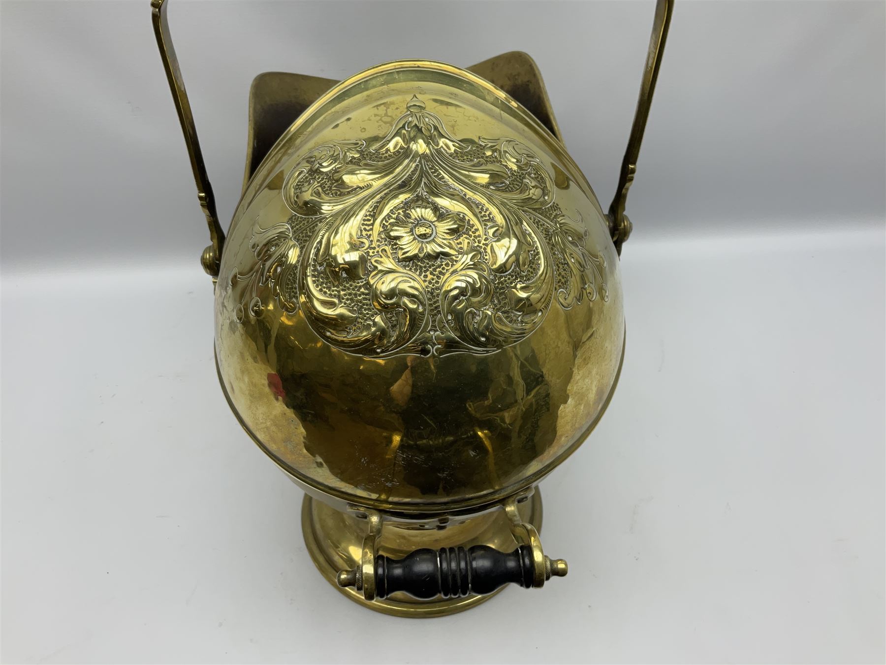 Victorian brass coal scuttle, of helmet form with turned ebonised handles, H48cm