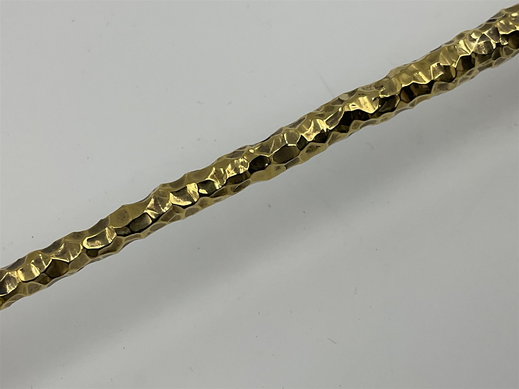 Pair of modern silver candlesticks by Stuart Devlin, the tapering parcel gilt stems with signature textured detailing, each supporting a fluted candle holder and upon a spreading circular foot, hallmarked Stuart Devlin, London 1973, H25cm