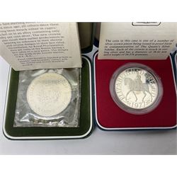 Seven The Royal Mint United Kingdom sterling silver proof crown coins, comprising two 1972, three 1977, 1981 and 1993, all cased with certificates and a Queen Elizabeth II 2001 one ounce fine silver Britannia coin on card (8)