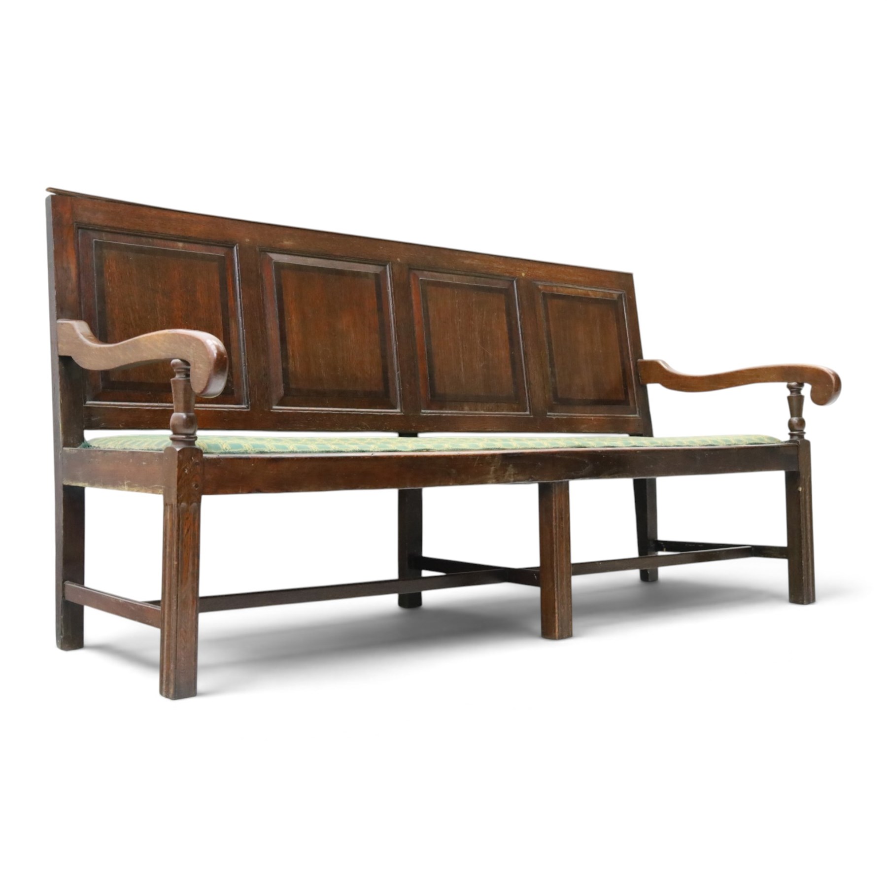 17th century design oak four panelled hall bench, fielded back panels flanked by swept arms on turned supports, raised on six supports united by a stretcher