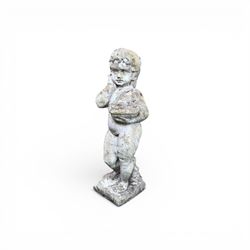 Early composition stone figure of a boy with grape basket, original flakey white paint