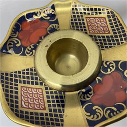 Pair of modern Royal Crown Derby Old Imari 1128 pattern candlesticks, each with shaped drip tray affixed to squat socket, upon spreading stem and canted square base with gilt dolphin edges, with printed marks beneath including Roman numeral year cypher for 2003, H26.5cm, with original boxes