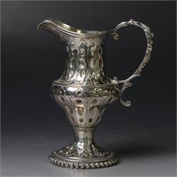George III silver cream jug, of baluster form with hammered dimpling throughout and scroll...
