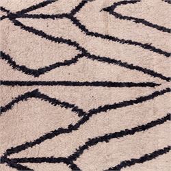 Moroccan Berber wool hand knotted rug, the cream ground decorated with abstract diamond forms and angular lines in dark brown, enclosed by a simple patterned border, with short fringe ends
