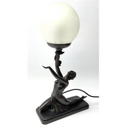 An Art Deco style composite bronze effect table lamp by Crosa, modelled as a semi nude female figure supporting a spherical crackle effect shade in her outstretched hand, overall approximately H47cm.