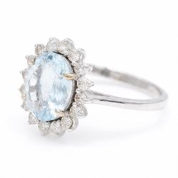 18ct white gold aquamarine and diamond cluster ring, single oval cut aquamarine of approx 2.05 carat, surrounded by sixteen round brilliant cut diamonds, stamped 18K, total diamond weight approx 0.50 carat