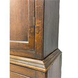George III oak livery cupboard, projecting moulded cornice over two panelled doors, the upper panels within stepped ogee and arched moulded frame, the interior fitted with a single row of wooden hooks, two short and one long drawers, on bracket and return skirted base 