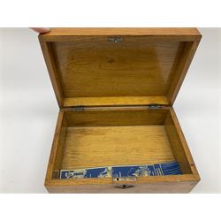 19th century mahogany tea caddy, of sarcophagus form upon four compressed bun feet, together with a 19th century mahogany box with mother of pearl escutcheon and vacant plaque to the hinged cover, an Edwardian mahogany twin handled tray, of oval form with inlaid shell detail to centre, etc. 