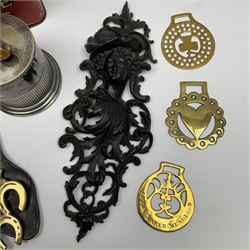 20th century cast iron wall bracket/pocket, modelled as a female mask with acanthus support, together with a silver plated tobacco jar with pipe finial to the cover, toffee tin detailed 'Riley's Toffee Rolls', and small group of brass horseshoes, in one box