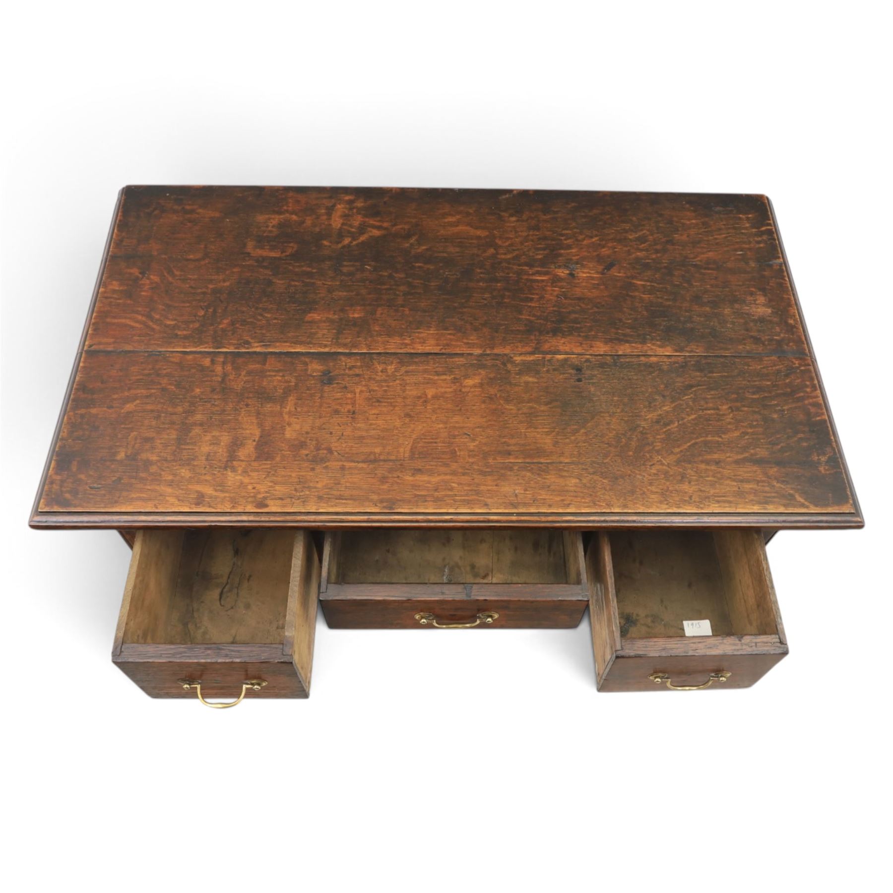 18th century oak lowboy, rectangular plank top with moulded edge, above three assorted drawers with brass swan neck handles, shaped apron raised on pad feet