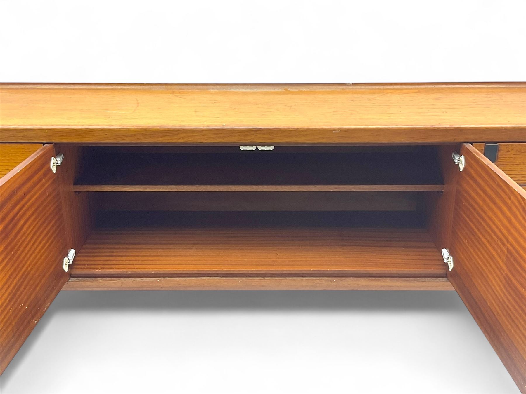 White & Newton - mid-20th century teak sideboard, rectangular top with raised back over fall-front storage compartment, double cupboard and three drawers, raised on cylindrical supports