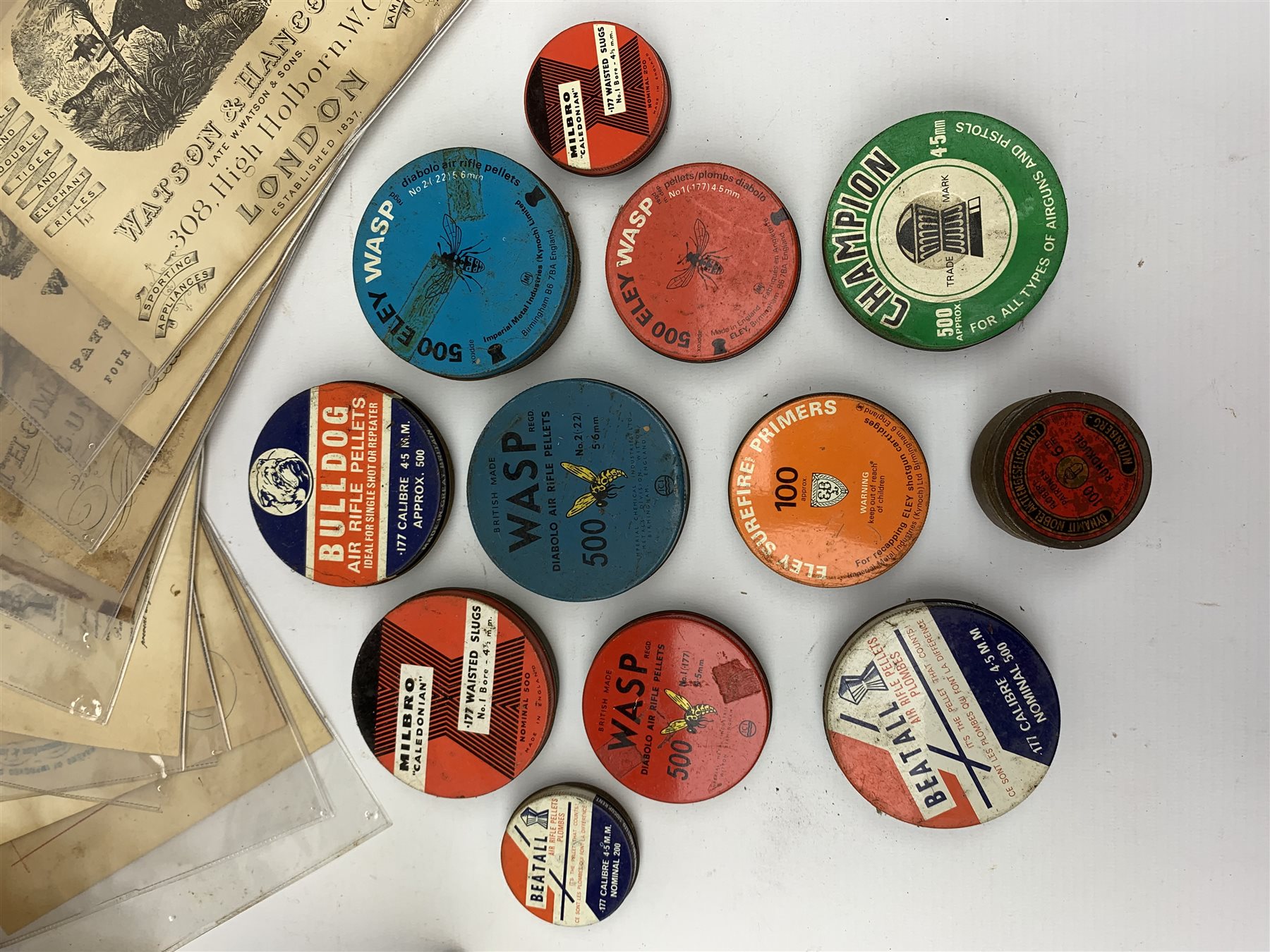 Brass and tin powder magazine by B.E. Chaplin of conical form with glazed see-through nozzle H27cm; eight reprinted gun case labels for Holland & Holland, Thomas Jackson & Son, William Ling, Watson & Hancock, Williams & Powell etc; and quantity of empty cartridge boxes and pellet tins