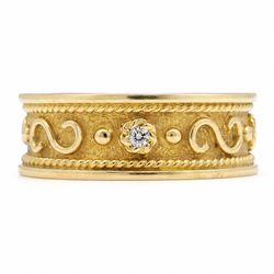 18ct gold diamond band, four round brilliant cut diamonds spaced by scroll and bead  motif...