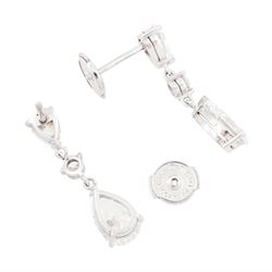 Pair of platinum diamond pendant earrings, each stud set with two pear cut diamonds, of 1.01 carat, 1.02 carat, 0.30 carat and 0.32 carat, spaced by a round brilliant cut diamond, total diamond weight 2.65 carat, each pear cut with a GIA certificate