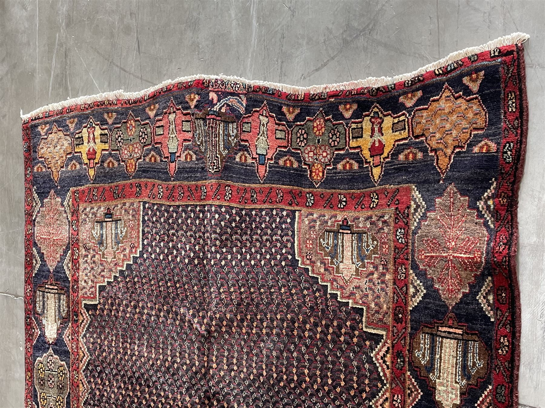 Persian Hamadan blue ground rug, medallion on field decorated with repeating motifs, the guarded border with multiple medallions decorated with flower heads and stylised motifs