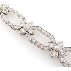 18ct white gold and platinum, milgrain set old cut diamond flower head and openwork panel link bracelet, total diamond weight approx 4.25 carat