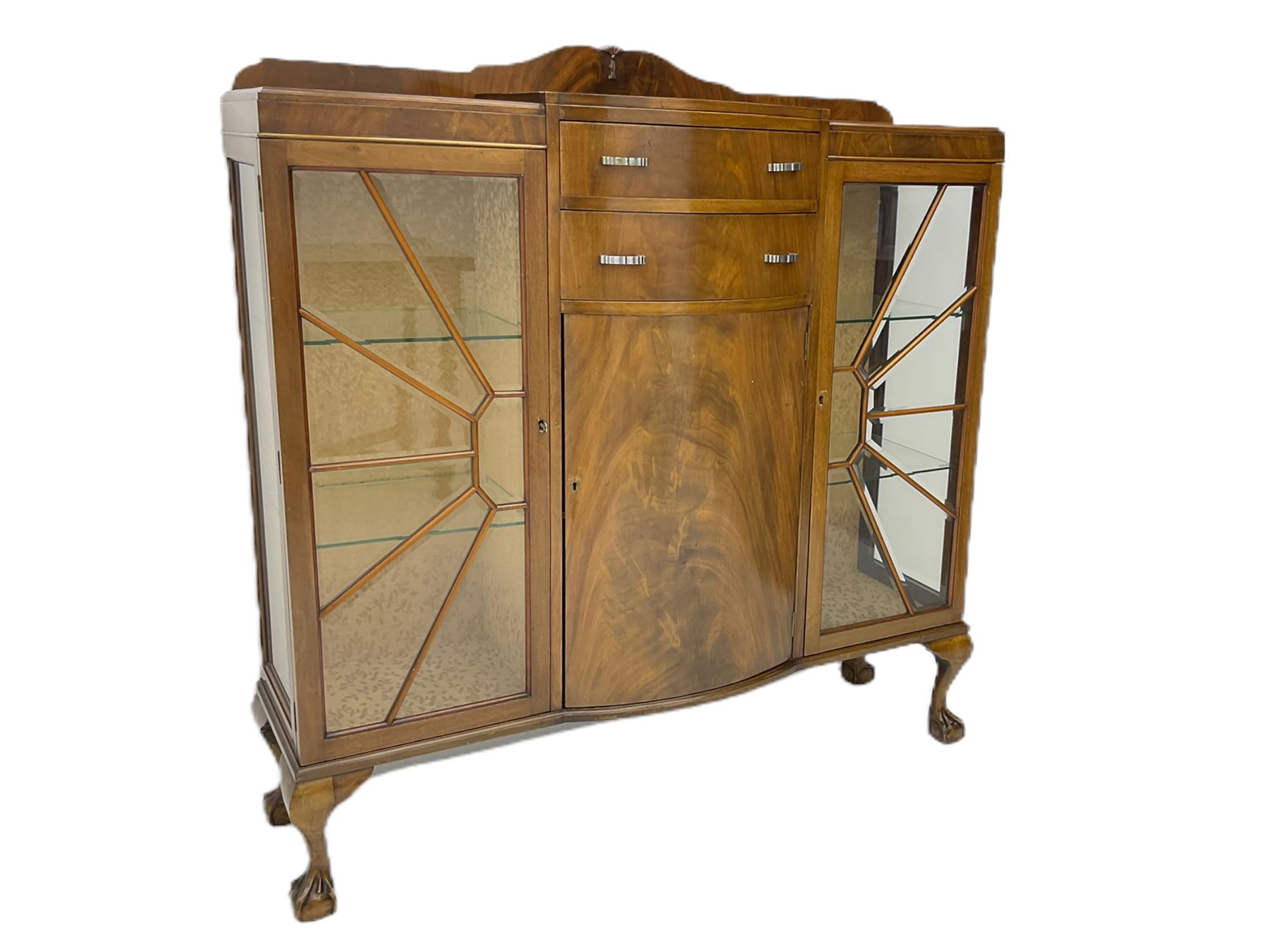 Mid-20th century Art Deco style walnut display cabinet, two central drawers over cupboard flanked by two bevel glazed display cabinets with sunburst astragal glazing, on ball and claw cabriole feet