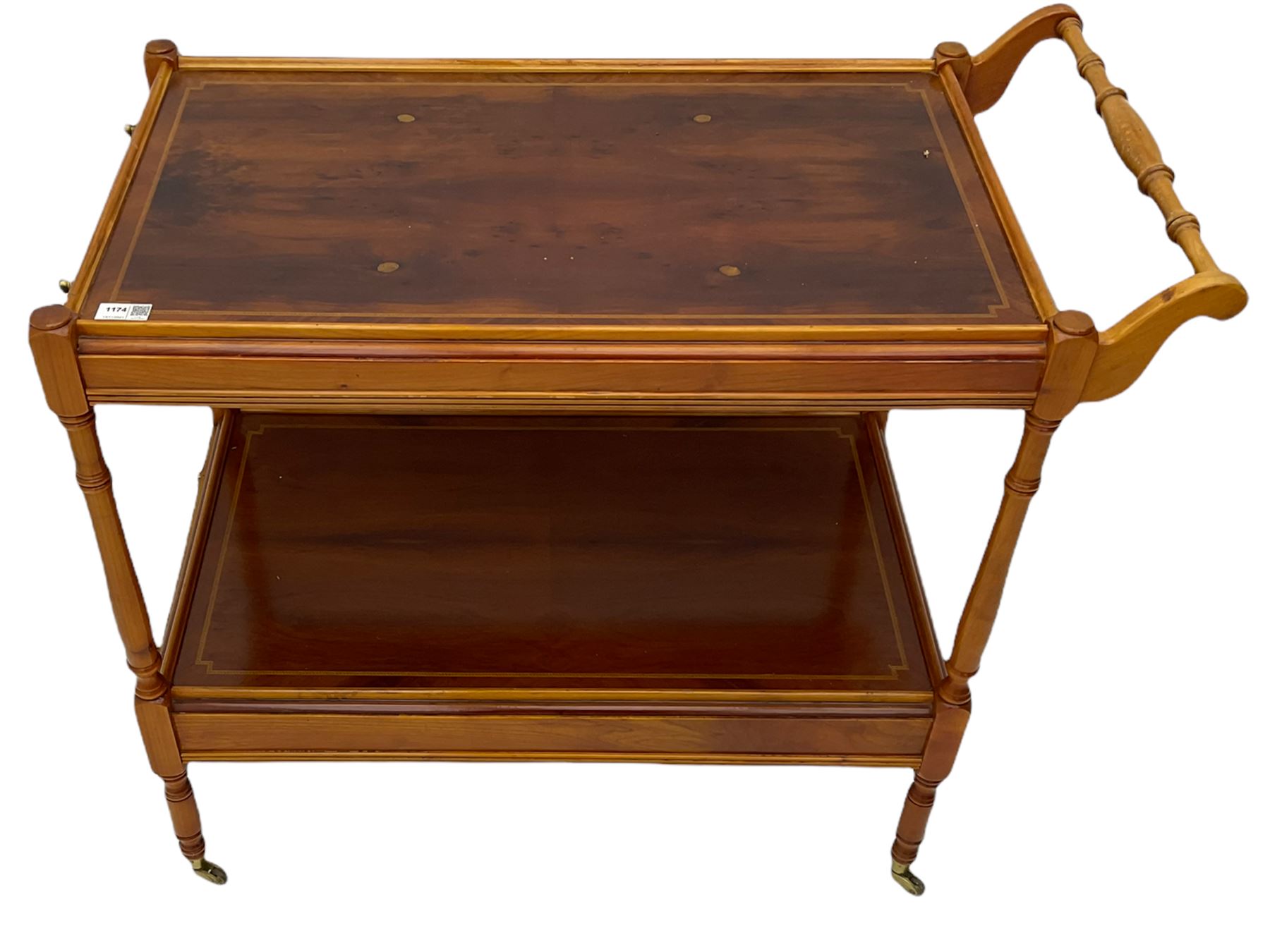 Yew wood drinks trolley, rectangular form with leather inset slide and turned handle, the undertier fitted with drawer, turned supports and brass castors
