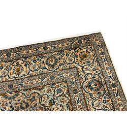 Persian Kashan golden ivory ground carpet, the central medallion surrounded by a field of interlacing branch and stylised plant motifs, the guarded border with scrolling design decorated with flower heads 