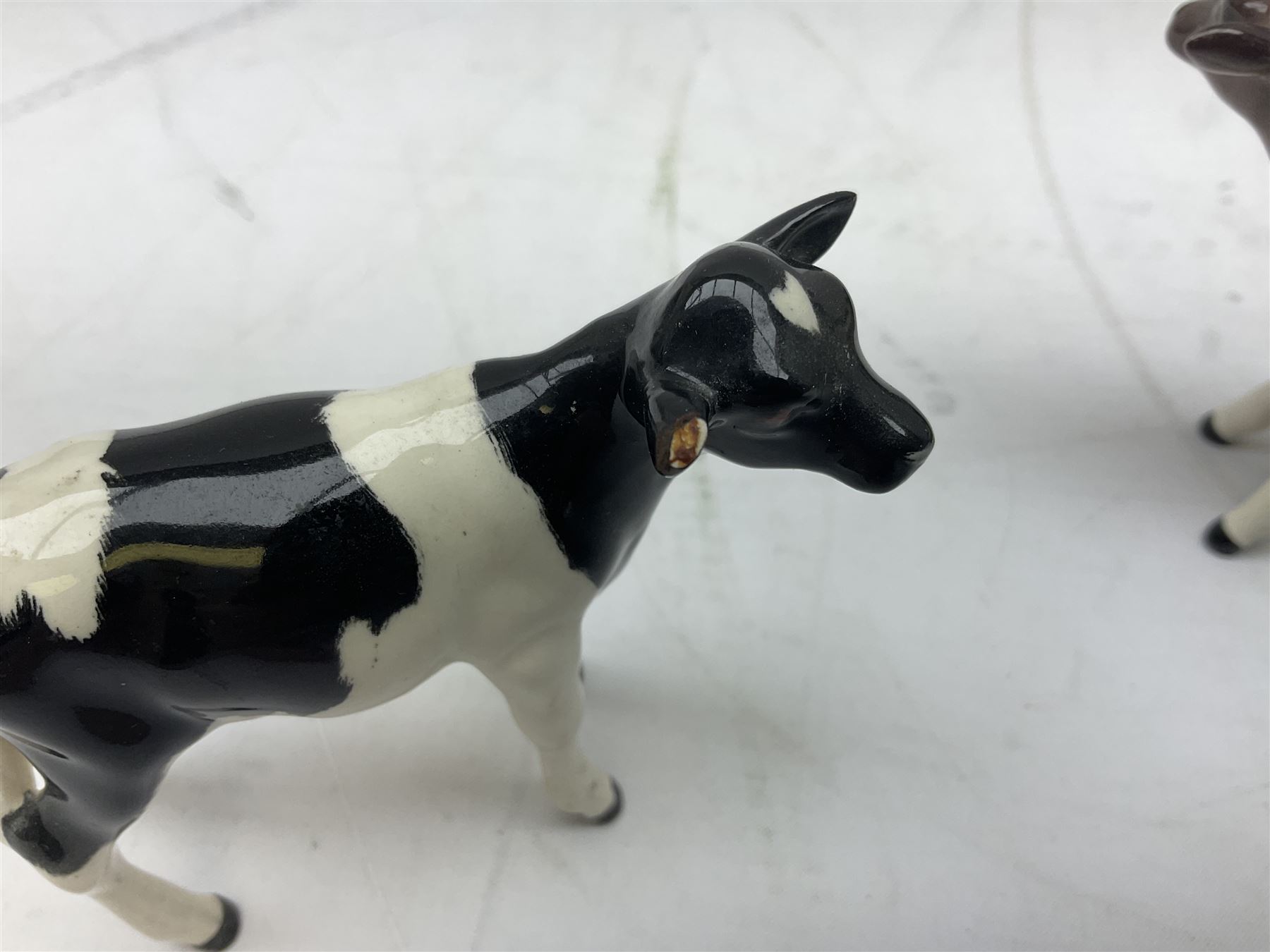 Seven Beswick cow figures, to include Friesian bull Ch. ''Coddington Hilt Bar'' no. 1439a, Friesian cow Ch. 'Claybury Leegwater' no. 1362a and Friesian calf no. 1249C, Aberdeen Angus calf 1827a, Jersey cow no. 1345 etc, all with printed mark beneath  