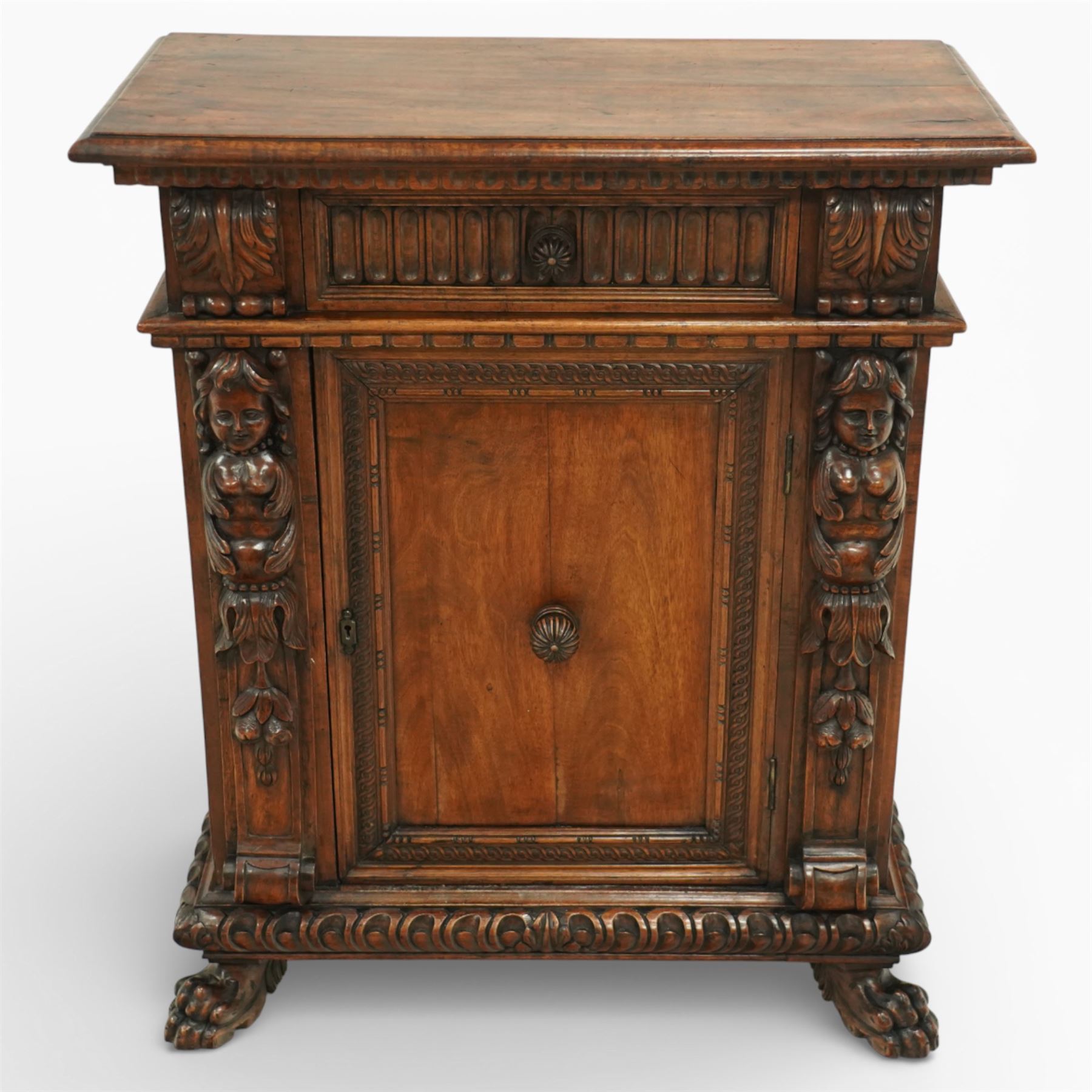 19th century Italian walnut Renaissance Revival side cabinet, the moulded rectangular top above a frieze drawer carved with vertical fluting and a central rosette, with egg-and-dart moulded rails to the top and base, acanthus-carved corbels below, the panelled cupboard door framed by beading and guilloche ornament, flanked by carved caryatids modelled as classical female architectural supports with foliate terminals, raised on paw feet