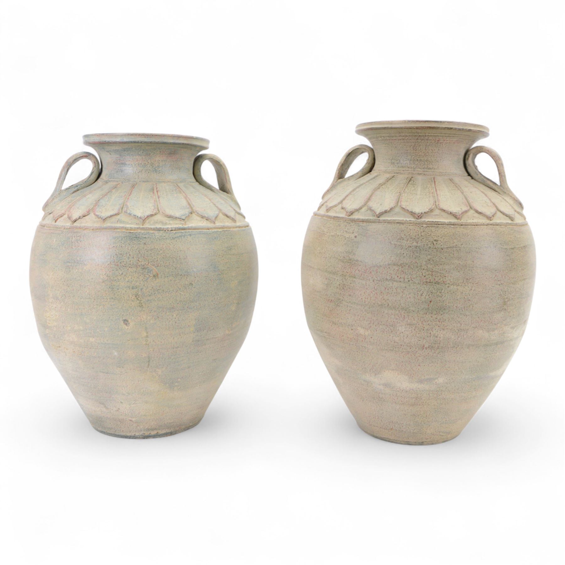 Two large Thai storage jars, with repeating leaf boarder to the neck