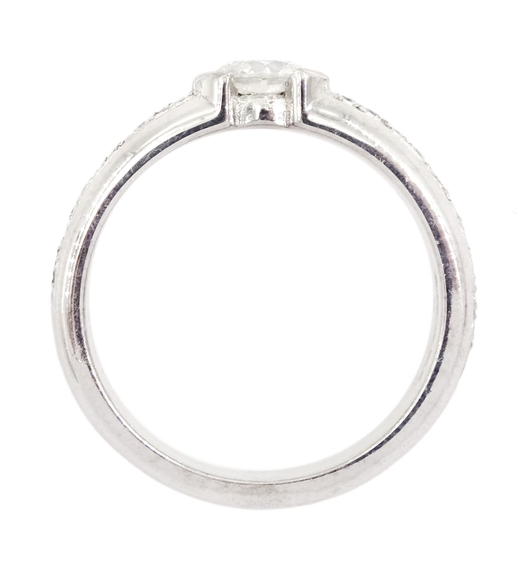 18ct white gold diamond ring, half bezel set with a single round brilliant cut diamond of approx 0.45 carat, with pave set round cut diamond shoulders, hallmarked