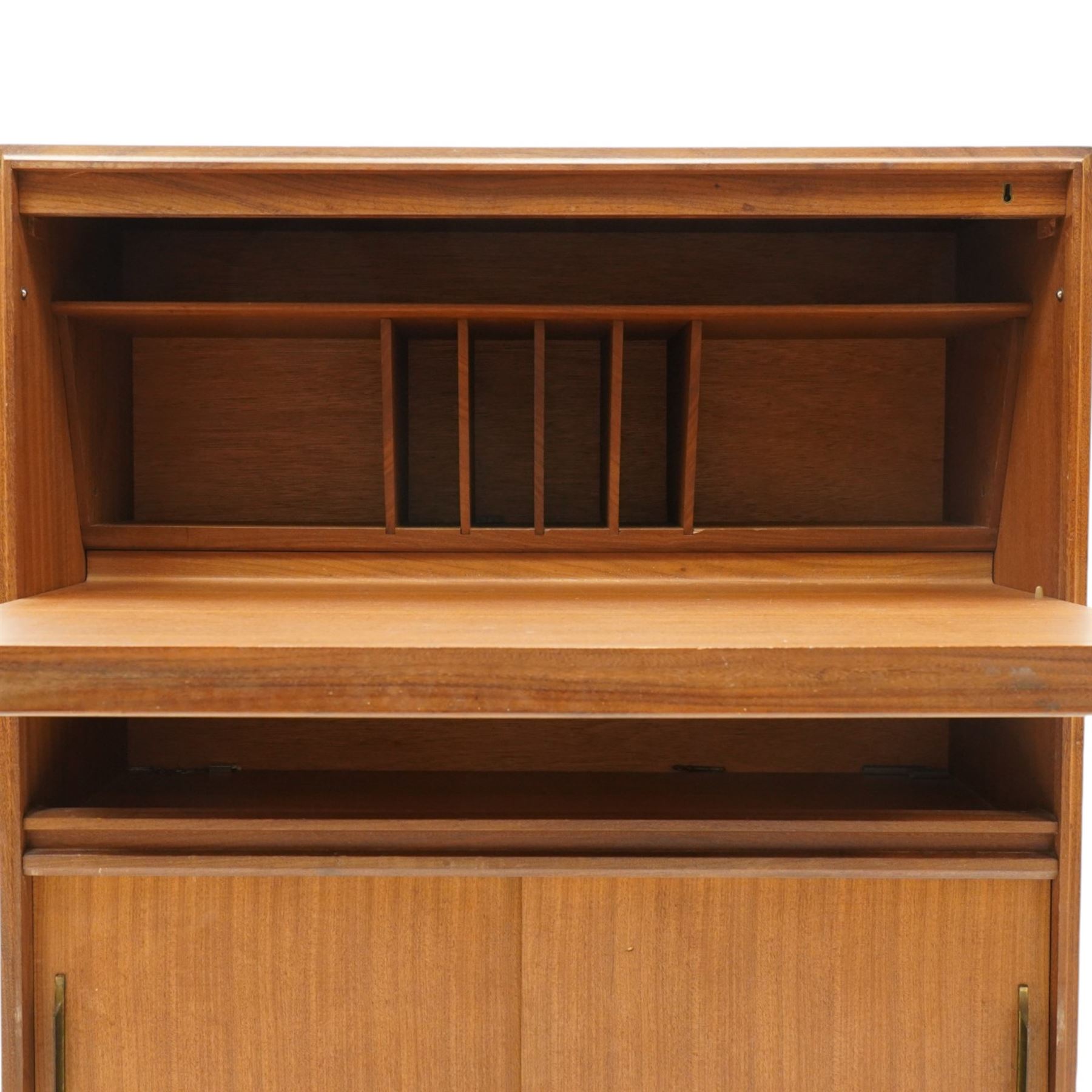 Robert Heritage (1927-2008) for Beaver & Tapley - Mid 20th century teak bureau, fall front with fitted interior, above a sliding door cabinet, raised on short supports