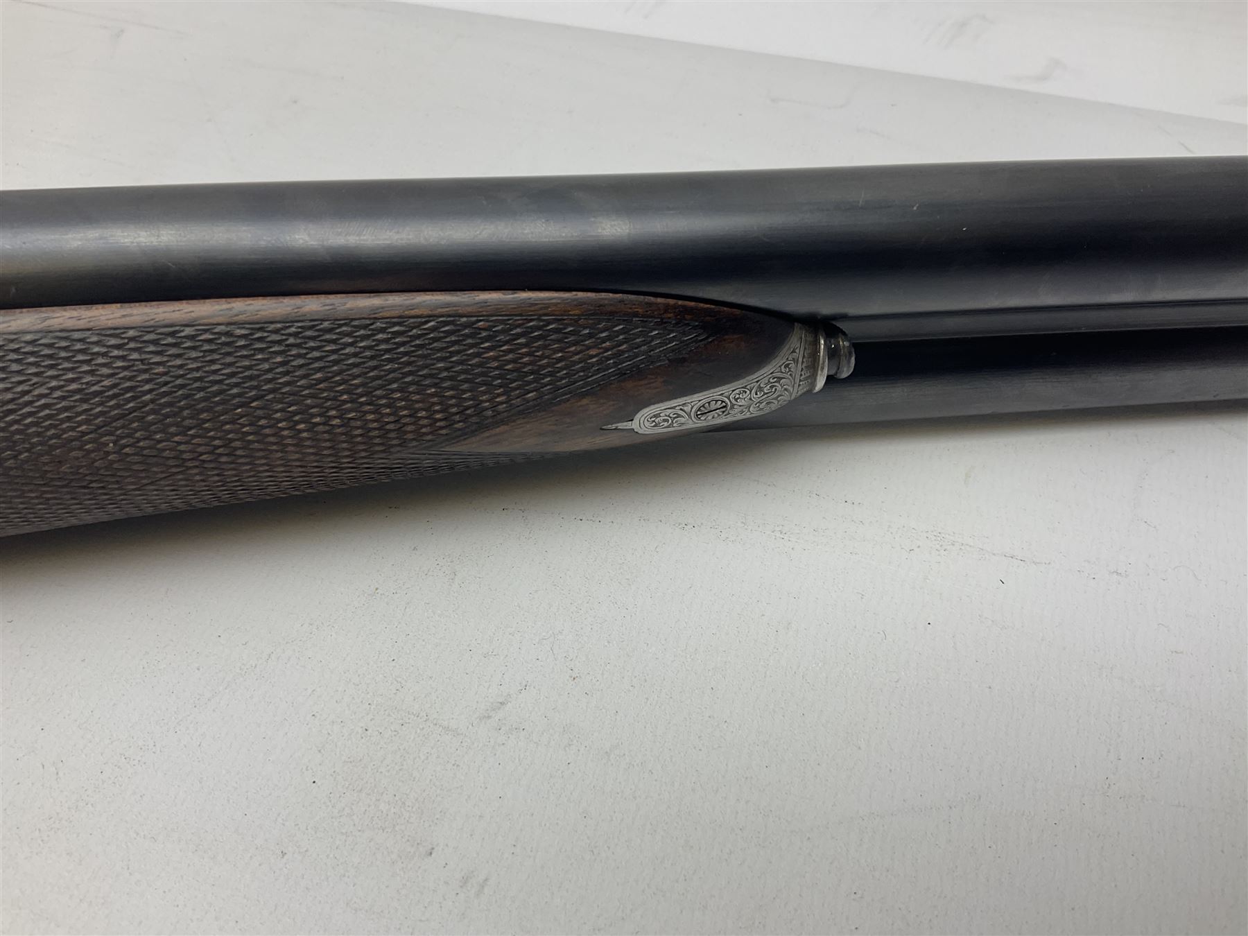 Smith Midgley Bradford 12-bore side-by-side double barrel side-lock ejector shotgun with 71cm barrels, engraved action with patented top lever, ivy leaf fences and top safety, walnut stock with chequered grip and fore-end, serial no.62409 to barrels and 1481 to action, L115cm overall SHOTGUN CERTIFICATE REQUIRED