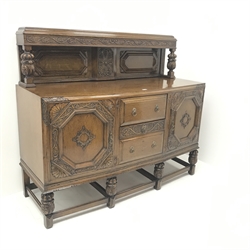 Early 20th century oak sideboard, raised back with carved cup and cover supports above three drawers flanked by two cupboards, carved supports joined by stretchers, W152cm, H133cm, D61cm