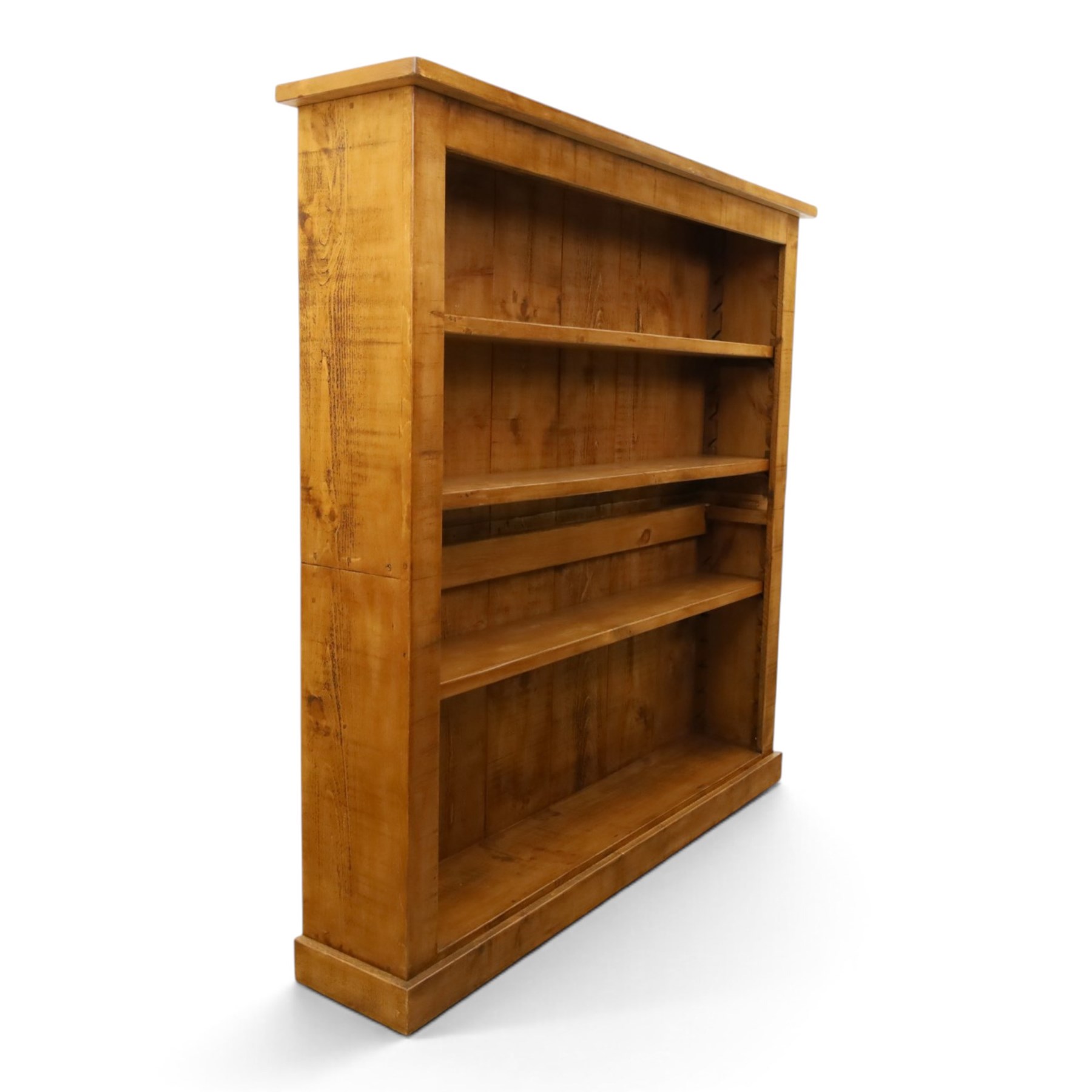 Indigo Furniture - large rustic oak open bookcase, with four adjustable shelves, above a plinth base 