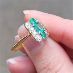 Early 20th century gold emerald and diamond panel ring, three octagonal cut emeralds, with four old cut diamonds set either side, stamped 18ct Plat, total diamond weight approx 0.85 carat