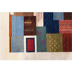 Persian style Gabbeh Loribaft design ivory ground rug, the vibrant field decorated with geometric patchwork design panels with interspersed stylised tree motifs, enclosed by a wide ivory guard band