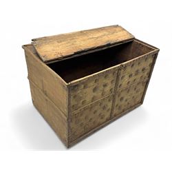 Late 19th century Afghan carved hardwood storage chest, the hinged plank top enclosing large internal storage space, geometric carvings to the front panels decorated with rows of riveted iron bosses