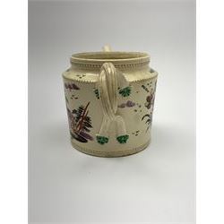 18th century creamware teapot, probably Leeds, with reeded entwined handle and floral finial to the cover, the body with hand painted polychrome decoration of figure to one side, and floral spray to the other, collectors paper label beneath inscribed Leeds Pottery, H11.5cm