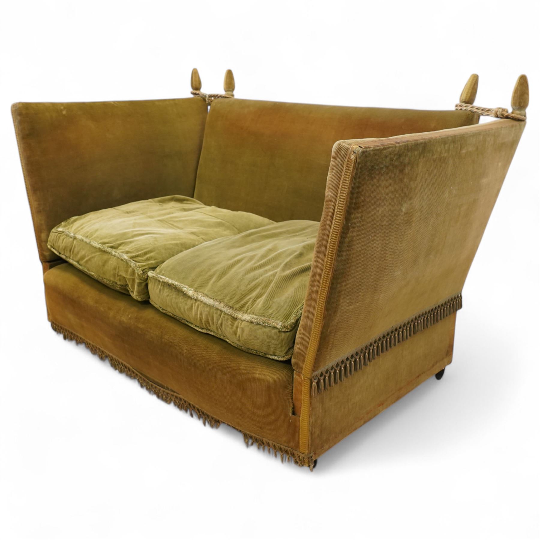 Mid-20th century Knoll style high back sofa, upholstered in olive green velvet with tassel fringe trim, sloped hinged arms and twin loose seat cushions, the frame surmounted by four finials
