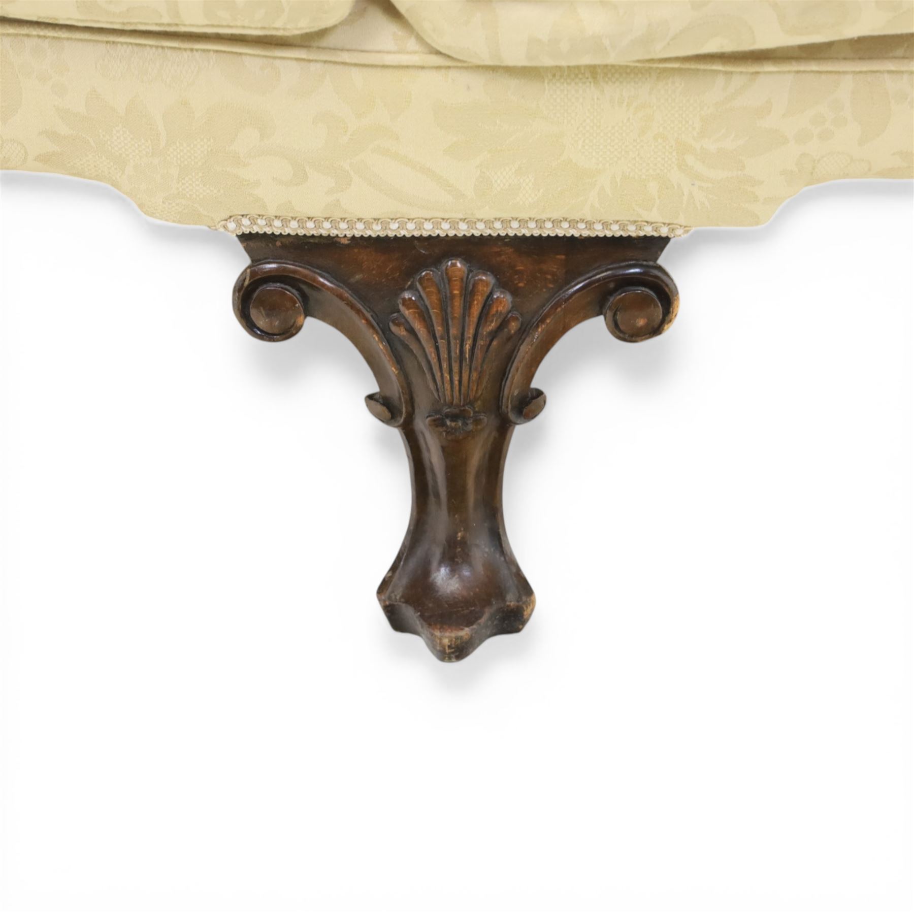 19th century Queen Anne style cream foliate upholstered three seat settee, the shaped and waisted back with serpentine cresting, padded arms over loose seat cushions, raised upon carved cabriole supports with shell carved knees