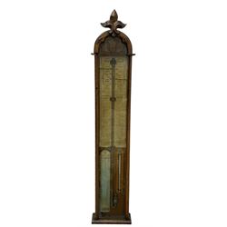 Admiral Fitzroy mercury barometer -  in a late 19th century fully glazed oak case c1870, with a round top and foliot carved arched crest, large bore bulb cistern tube, original charts annotated with Fitzroys remarks and observations,  twin vernier rack operated pointers, surface mounted mercury Fahrenheit thermometer and convex atmosphere/altitude chart.