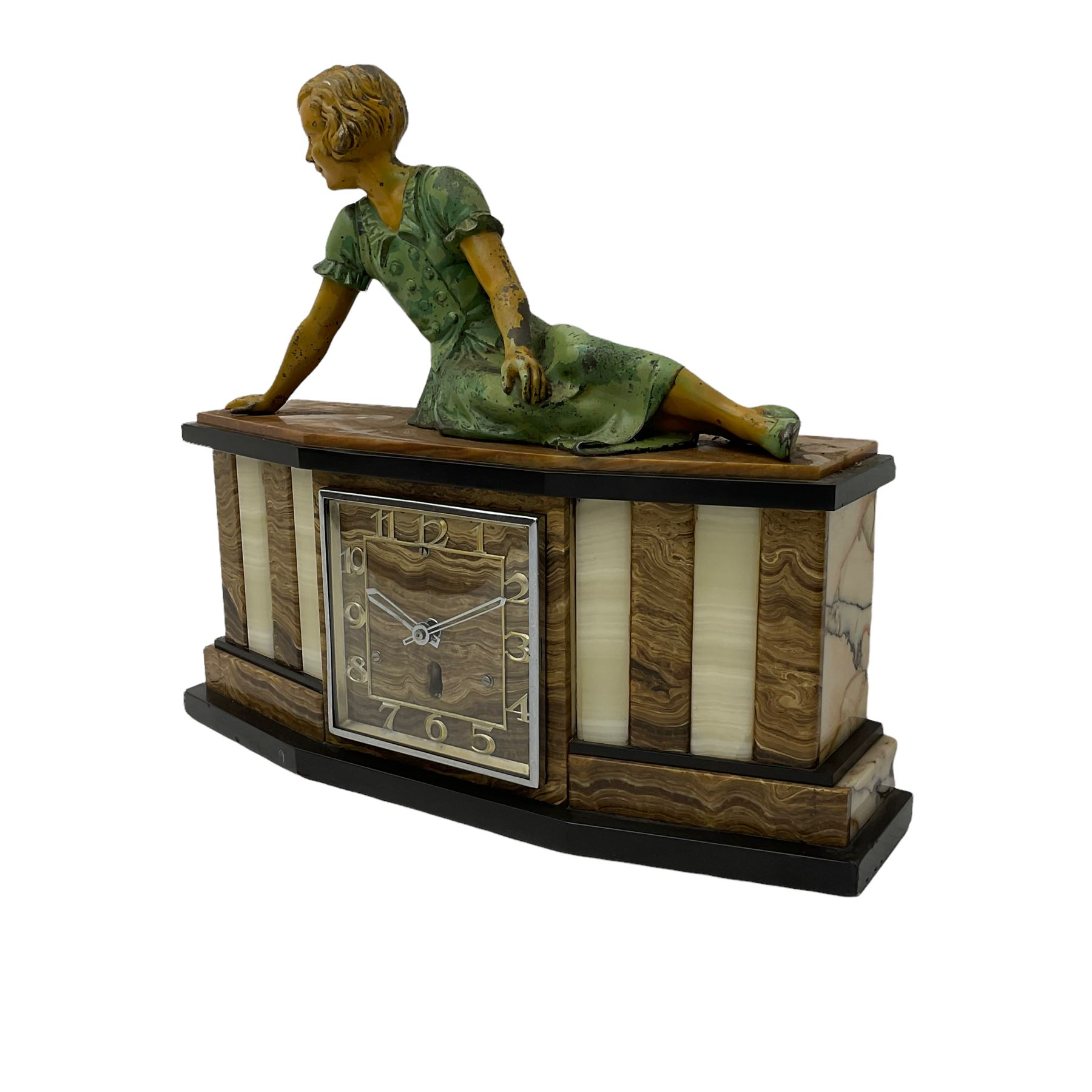A 1950's Art Deco mantle clock in contrasting black, white and brown onyx marble, surmounted by a reclining spelter figure of a young lady, with a 6” square dial with a chrome bezel, Arabic numerals and chrome baton hands, with a timepiece spring driven movement.  With pendulum.

